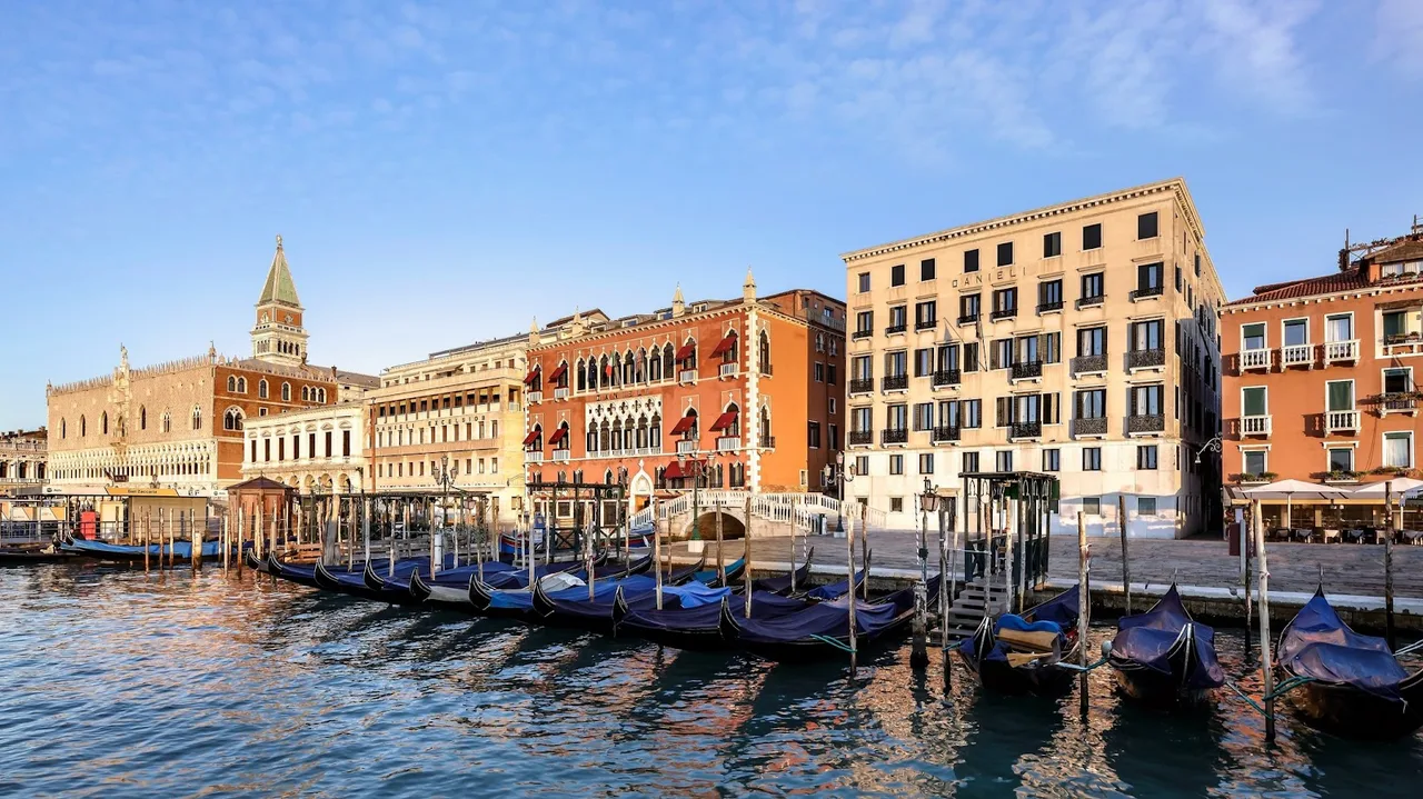 Danieli A Four Seasons Hotel Venice facade on Riva degli Schiavoni with Gothic arched windows and a terrace overlooking the lagoon