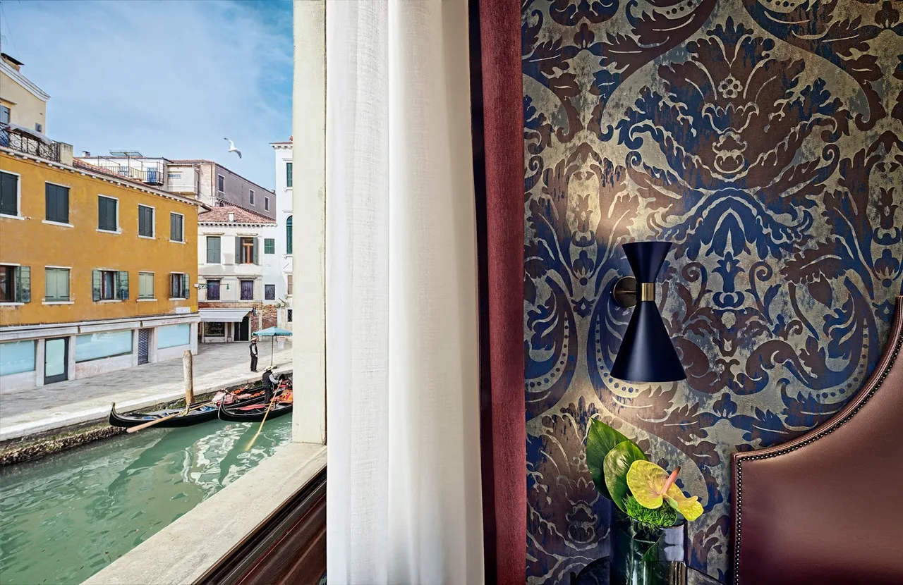 Hotel American Dinesen Venice 18th-century facade on Fondamenta Bragadin with green shutters and a private wooden boat landing