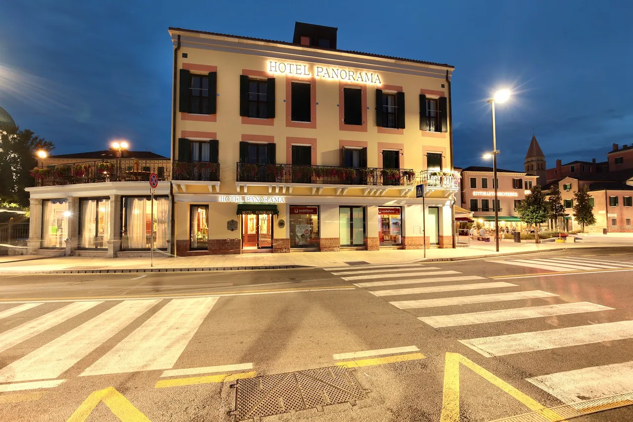 Hotel Panorama facade opposite Piazzale Santa Maria Elisabetta with a rooftop terrace, the lagoon vaporetto stop visible across the square