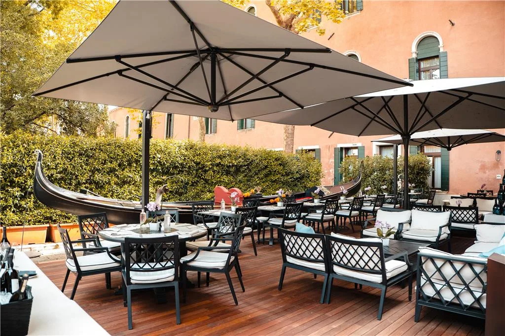 Radisson Collection Hotel Palazzo Nani facade on Fondamenta Cannaregio, a wide canal in front with moored delivery boats