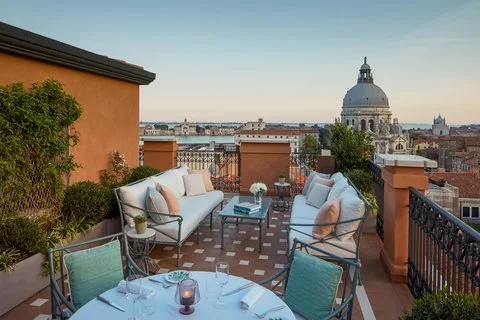 The St. Regis Venice facade on the Grand Canal, 19th-century arched windows and a private water entrance, neutral daylight